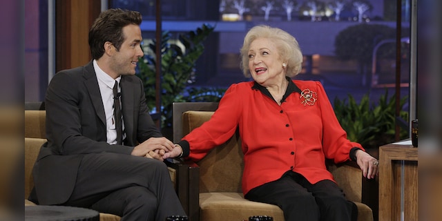 In the caption for his video, Reynolds (left) described his co-star in The Proposal Betty White (right) as 
