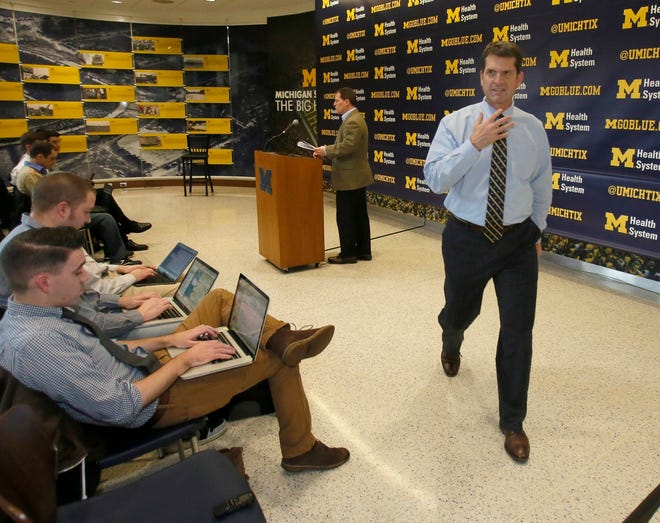 Michigan coach Jim Harpo turns away after completing his first signature day press conference in Michigan at the Chembeciller Hall on Wednesday February 4, 2015.