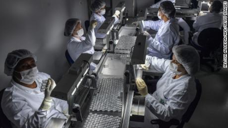 Employees work on the CoronaVac vaccine production line, Sinovac Biotech against Covid-19 Coronavirus at the Botantan Biomedical Production Center, in Sao Paulo, Brazil, on January 14, 2021. 